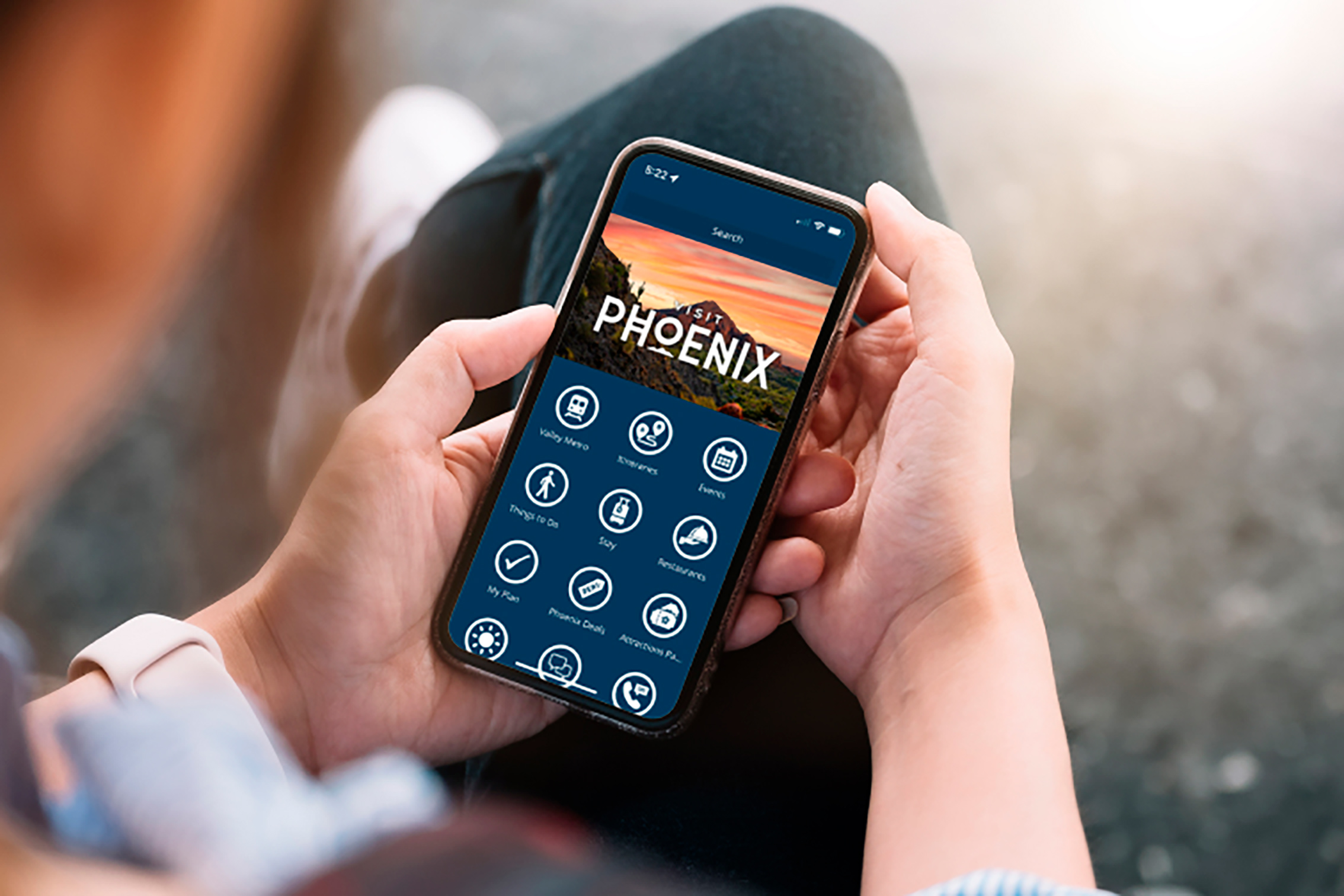 Person using Visit Phoenix branded mobile app by Visit Widget.