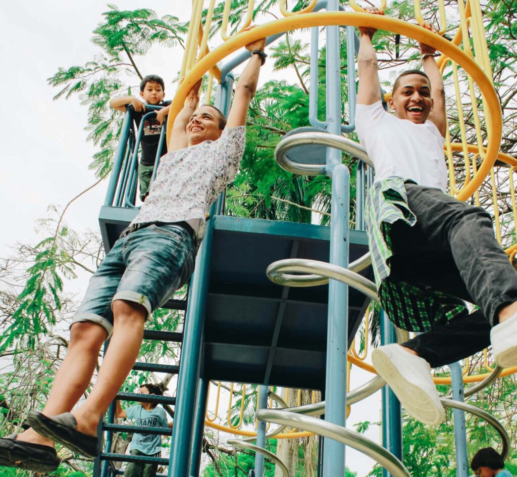 kids hanging from a jungle gym